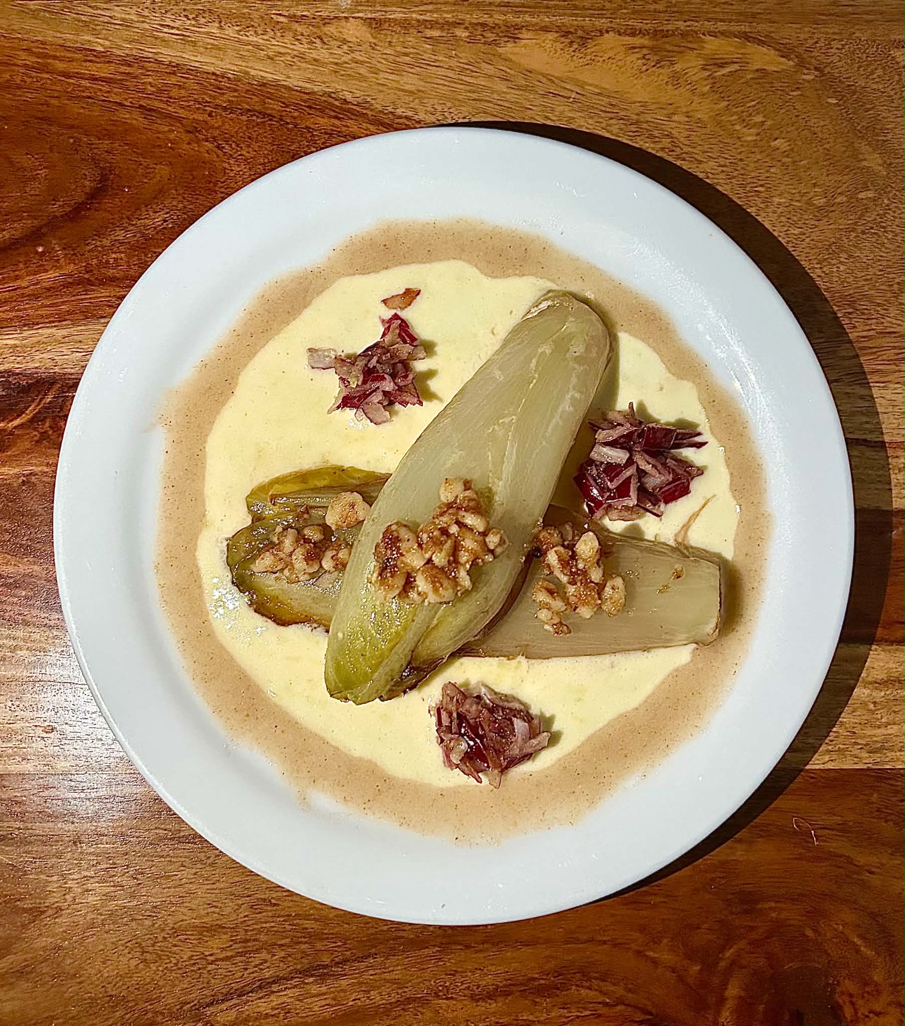 Braised endive with toasted walnuts and lemon cream