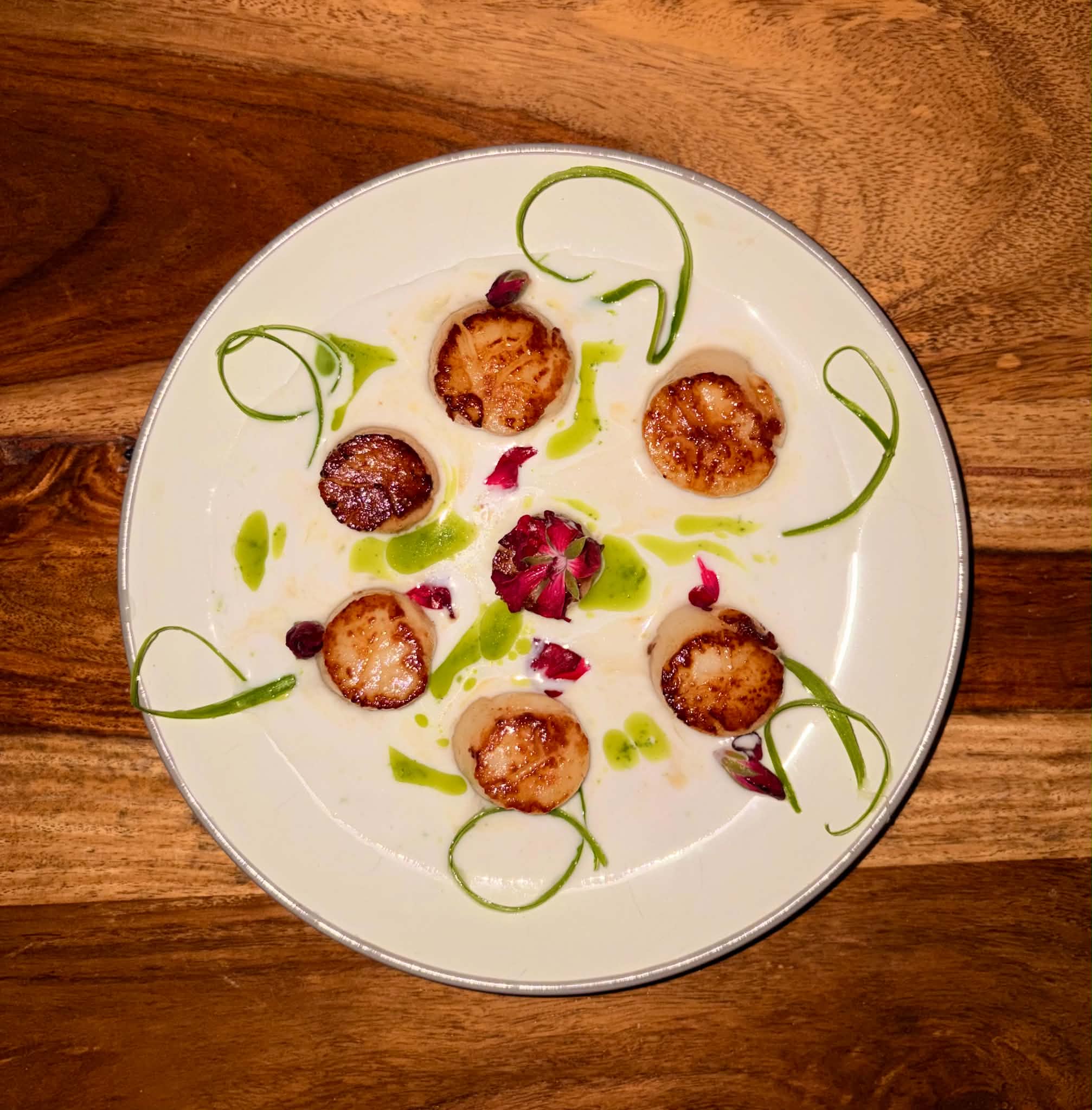 Seared scallops in a Thai coconut sauce with basil oil